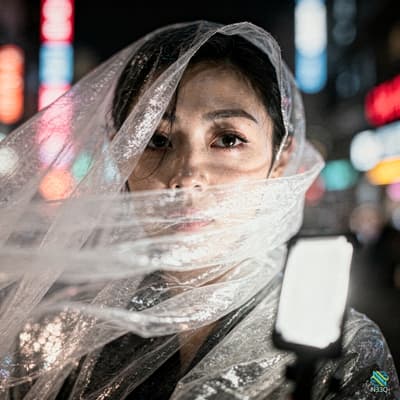 Woman Veiled in Crinkled Plastic at Night
