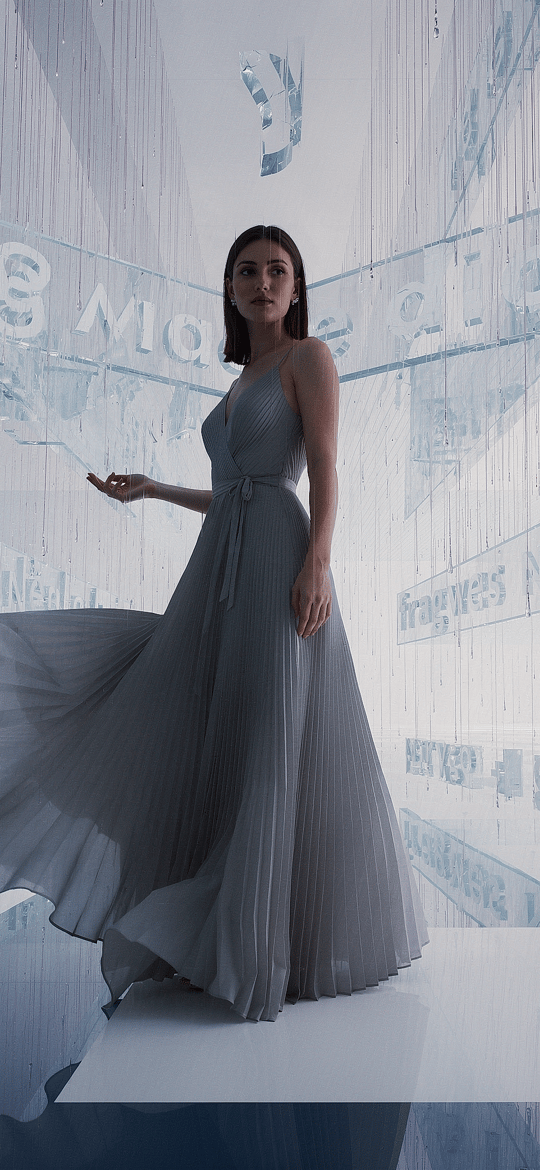 Woman in Gray Gown Amid Digital Fragments