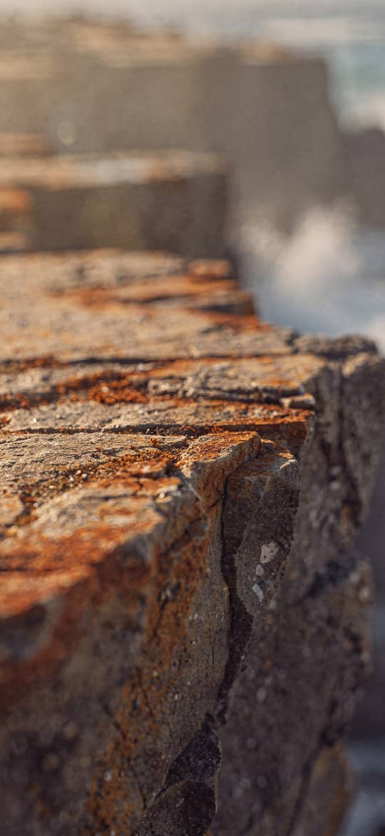 Rusted Concrete Seawall Edge by Ocean