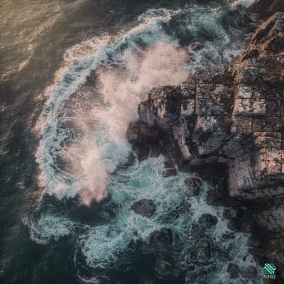 Waves Crashing Against Rocky Coastal Cliffs