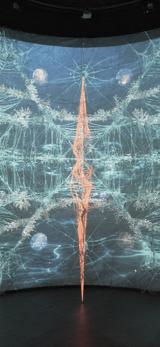 Orange Twisted Spire Before a Shattered-Glass Projection