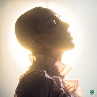 Woman with Shaved Head in Golden Halo