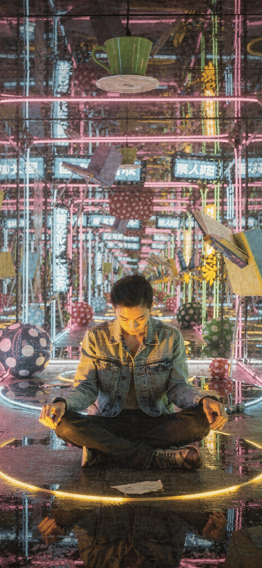 Man Meditating in a Neon Mirror Room