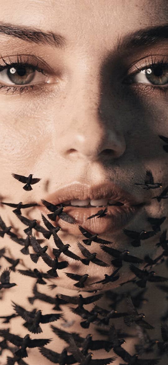Woman's Face Swarmed by Black Birds