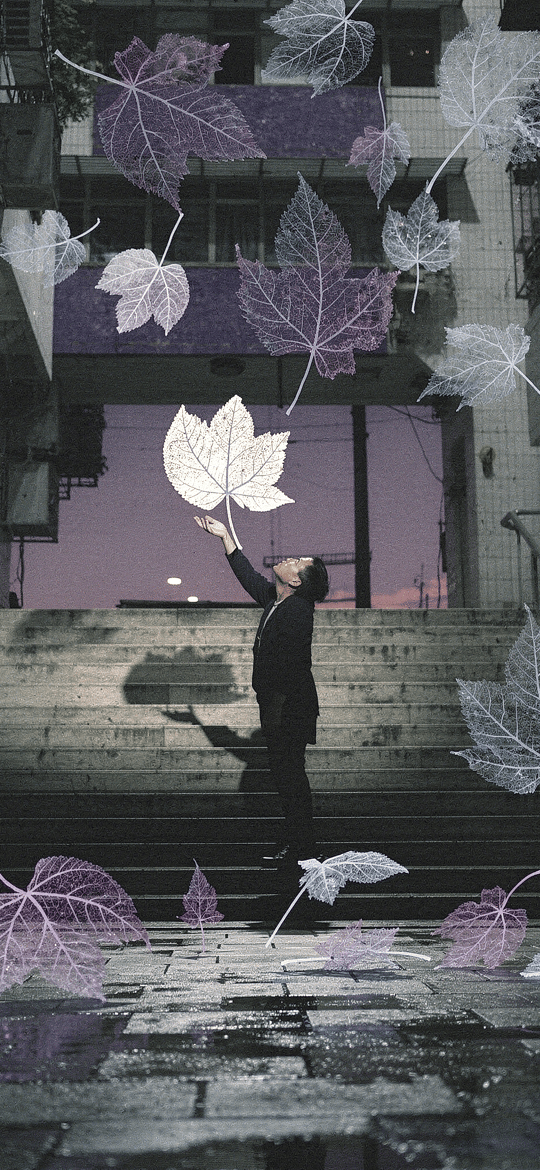Man Reaching for Falling Leaves in a Stairwell Courtyard