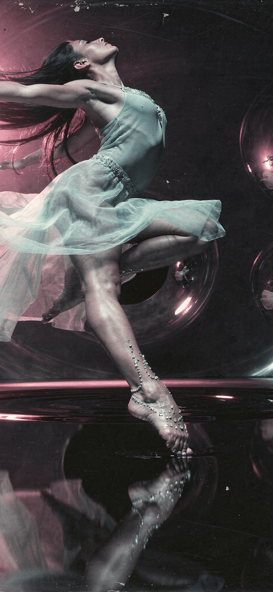 Dancer Leaping Amid Reflective Spheres
